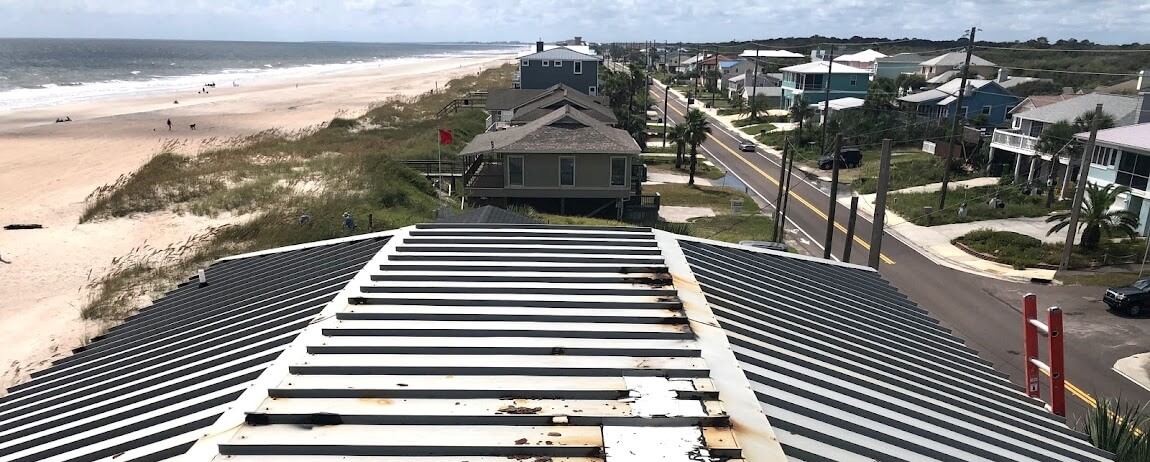 damaged roof overlooking beach and neighborhood