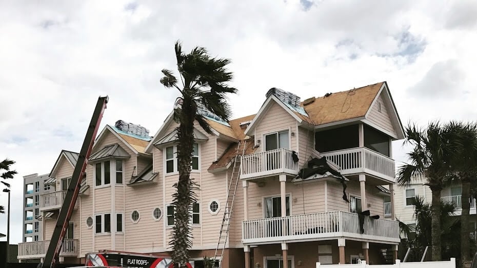 storm damaged roofs of apartments