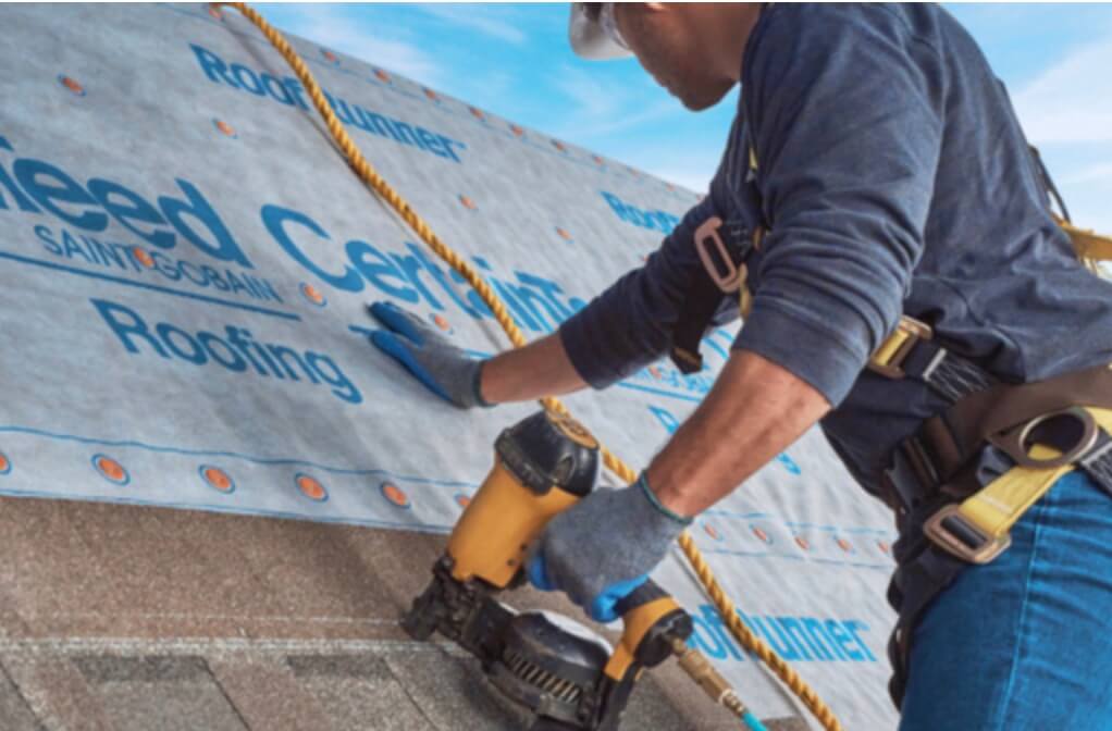 A roofer installing CertainTeed LandMark Pro Shingles in Sunrise Cedar