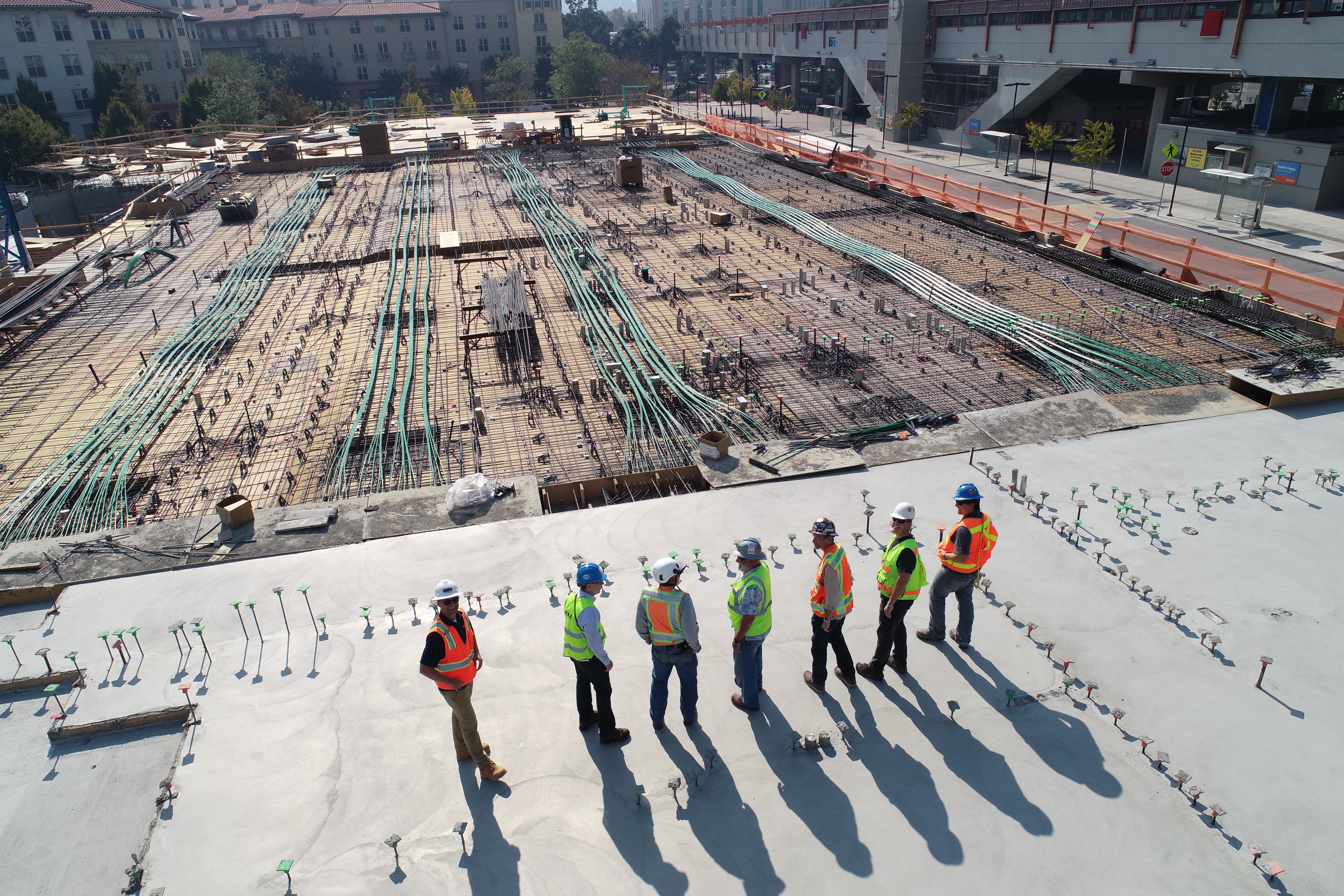 roofers standing on roof of commercial building