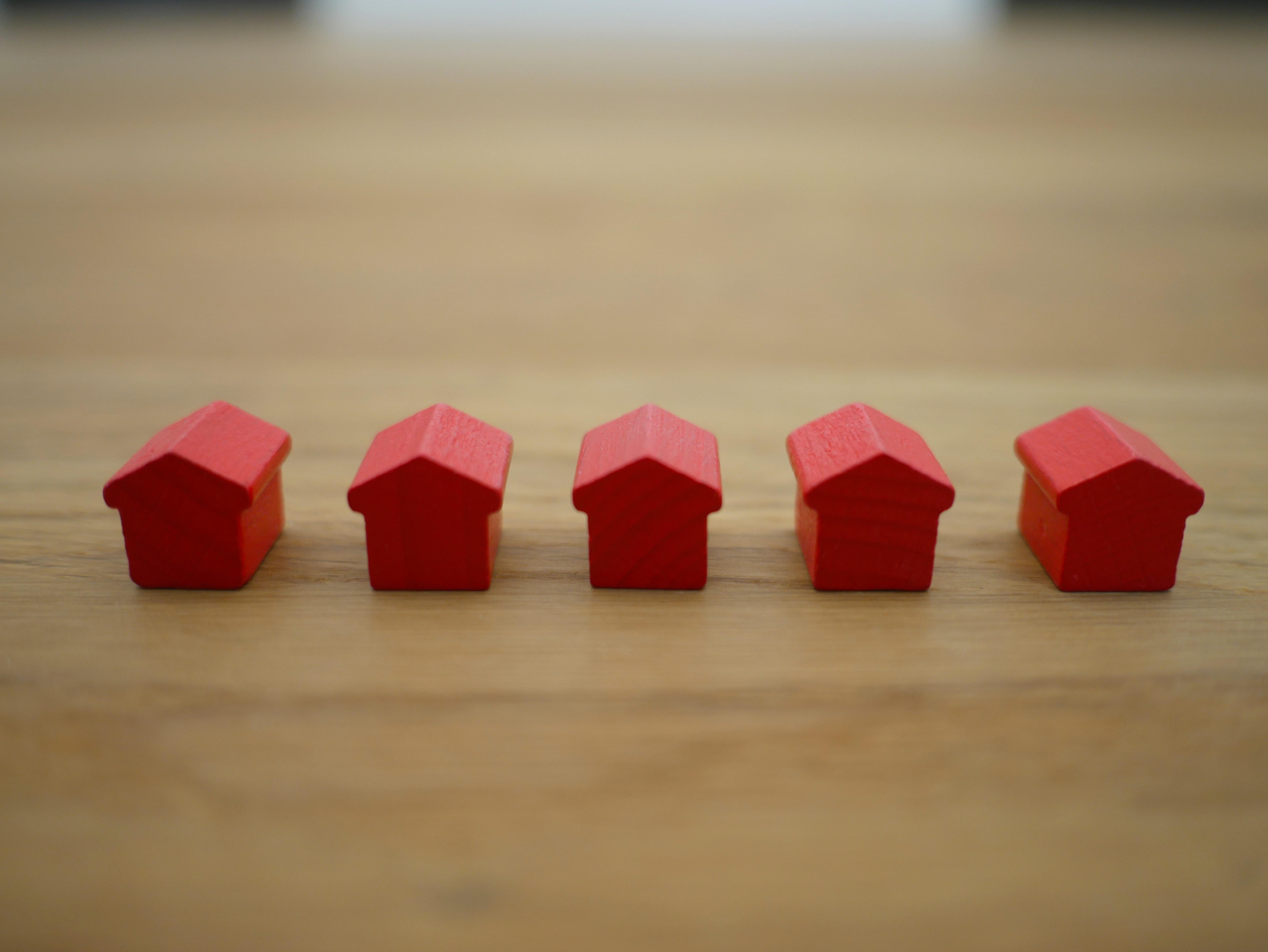 small red house figurines in a row