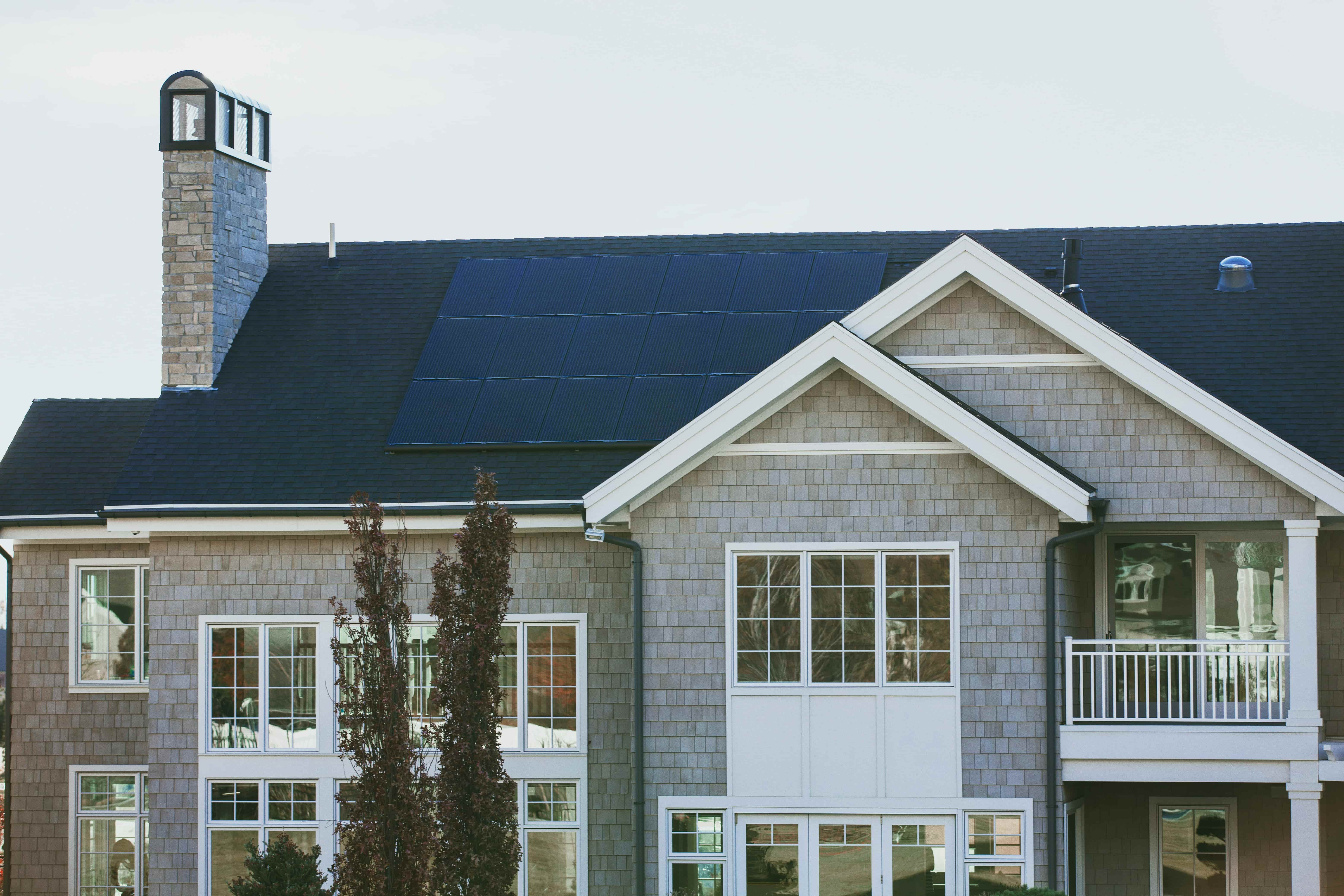 roof solar panels installed on large grey home